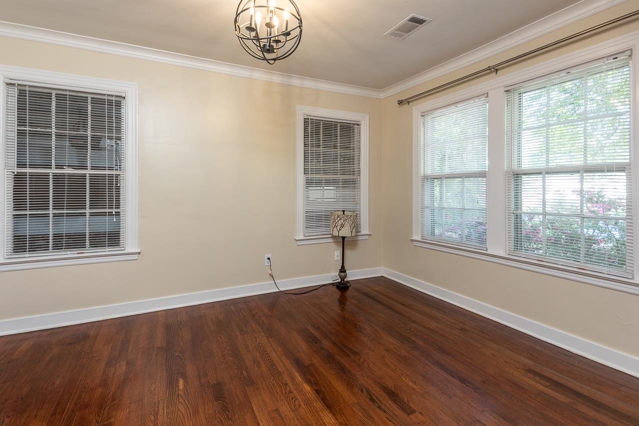 1264 Dovecrest Road Memphis, TN 38134 - Photo 17 of 30 a view of an empty room with wooden floor and a window