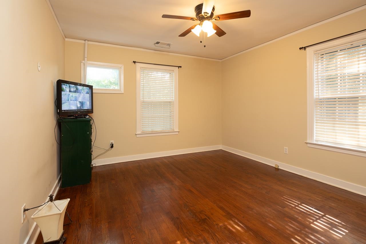 1264 Dovecrest Road Memphis, TN 38134 - Photo 18 of 30 a view of an empty room with a window and wooden floor