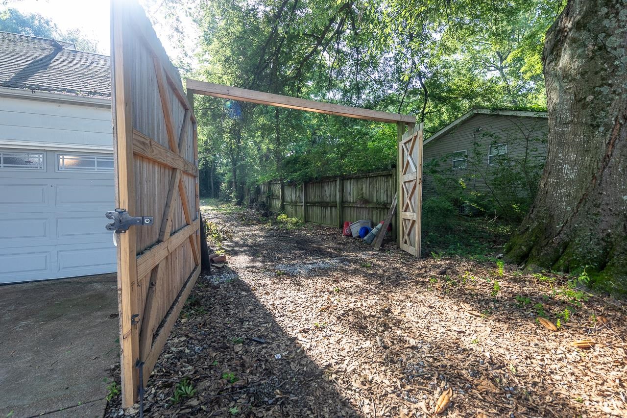 1264 Dovecrest Road Memphis, TN 38134 - Photo 22 of 30 a view of a backyard with a tree