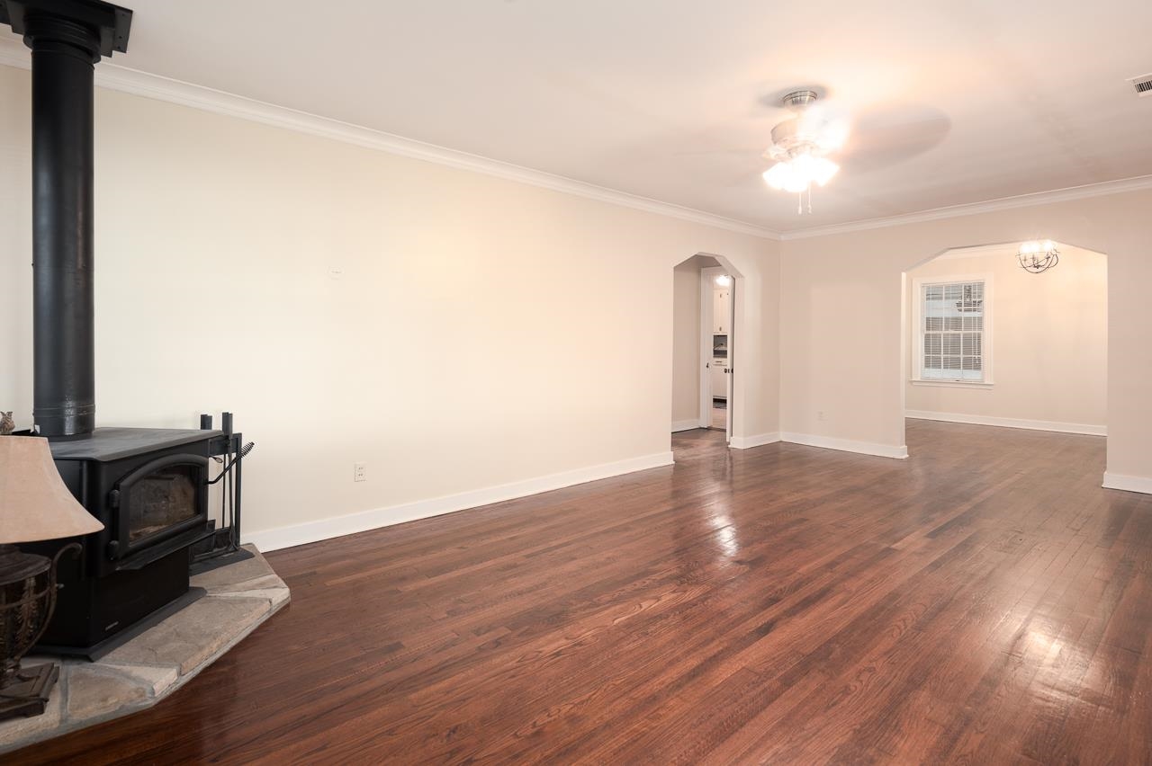 1264 Dovecrest Road Memphis, TN 38134 - Photo 7 of 30 a view of an empty room with wooden floor and a window