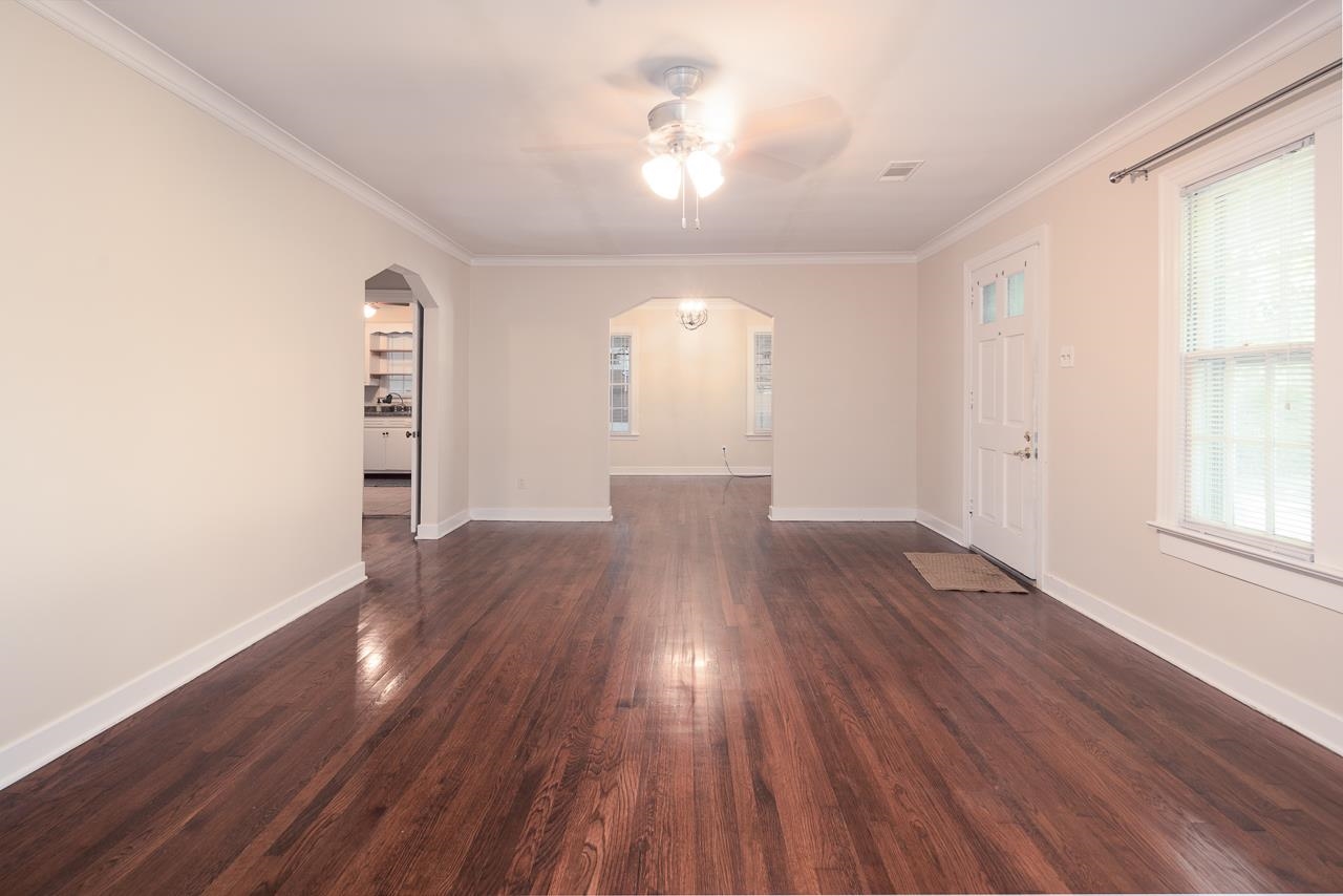 1264 Dovecrest Road Memphis, TN 38134 - Photo 9 of 30 an empty room with wooden floor and windows