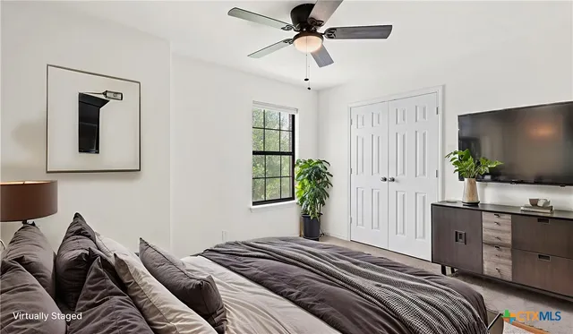 a bedroom with a bed and a potted plant