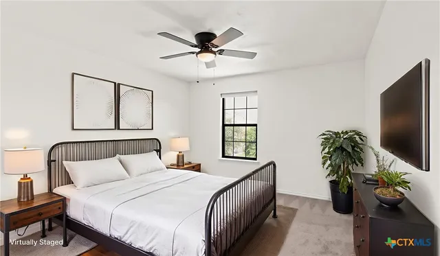 a bedroom with a bed and a potted plant