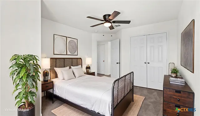 a bedroom with a bed and a potted plant