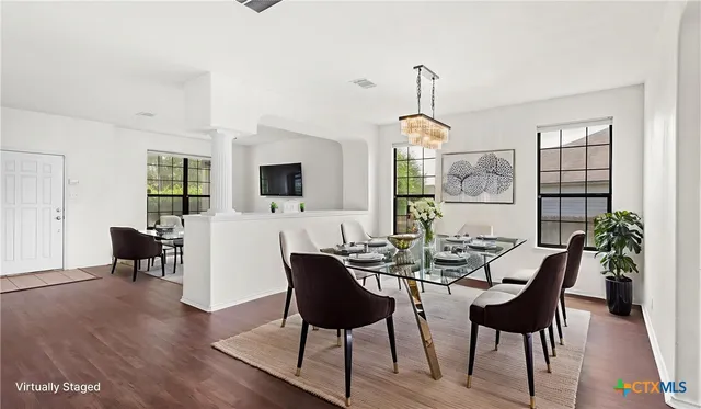 a view of a dining room with furniture window and wooden floor