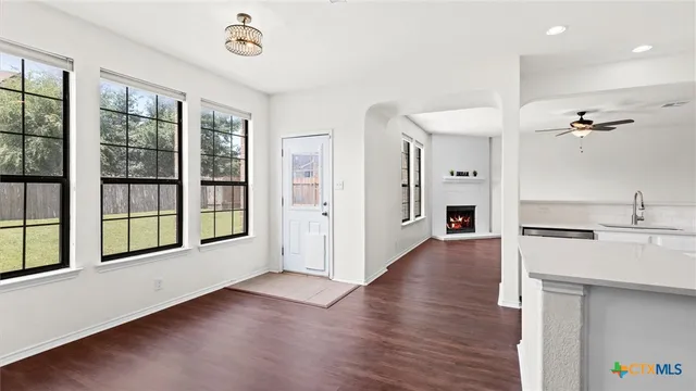a view of a kitchen with a sink hardwood floor and a large window