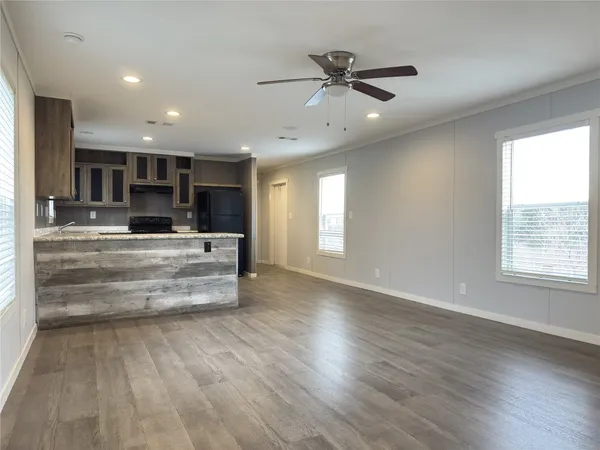 a view of kitchen center island wooden floor and window