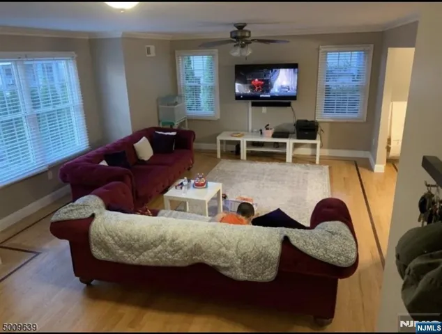 a living room with furniture and a flat screen tv