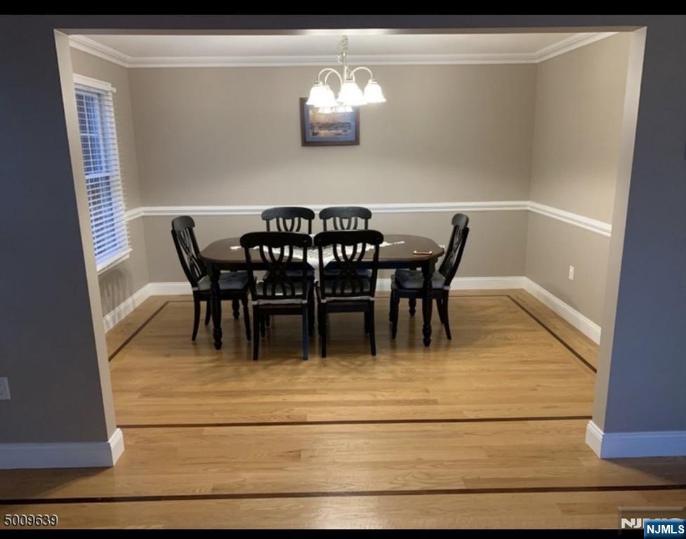 26 Sampson Street, Unit 1 Garfield, NJ 07026 - Photo 3 of 12 a view of a dining room with furniture and chandelier