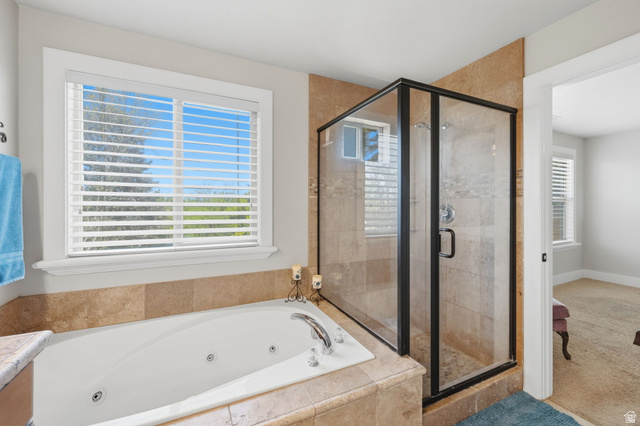 1683 North Main Street Centerville, UT 84014 - Photo 18 of 37 Bathroom featuring a jetted soaking tub, a glass-enclosed shower with tiled walls, and a window with blinds