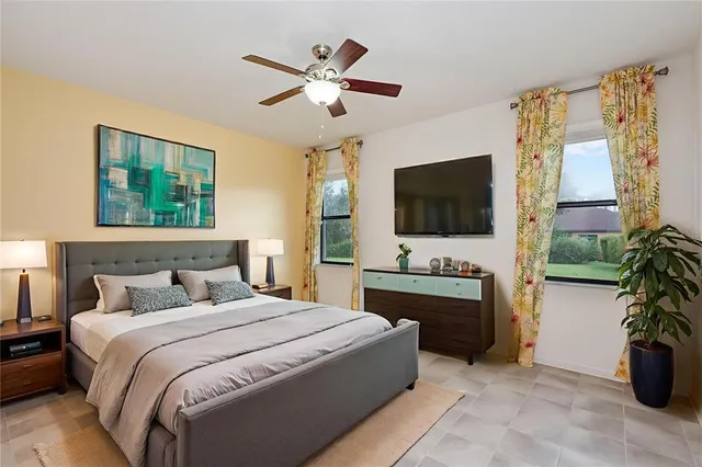 a bedroom with a large bed and a flat screen television