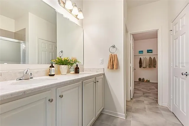 a bathroom with a double vanity sink and mirror
