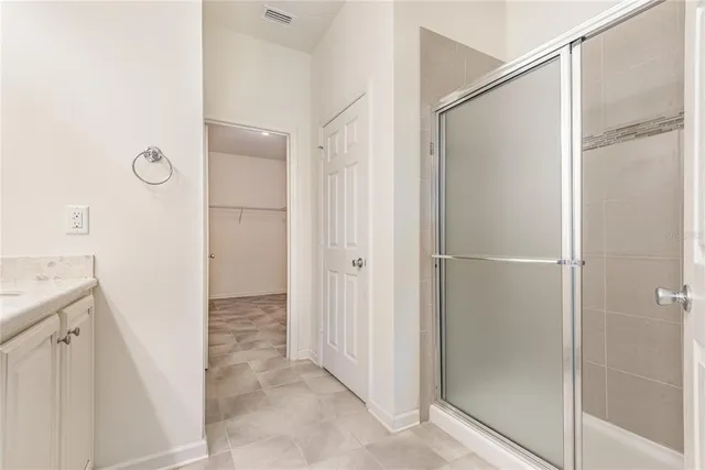 a view of a bathroom with a shower and a sink