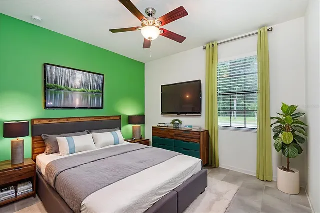 a bedroom with a bed and a flat screen tv