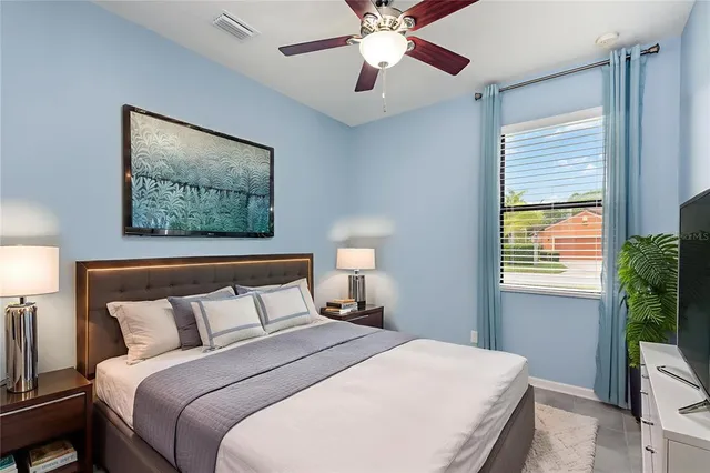 a bedroom with bed and window