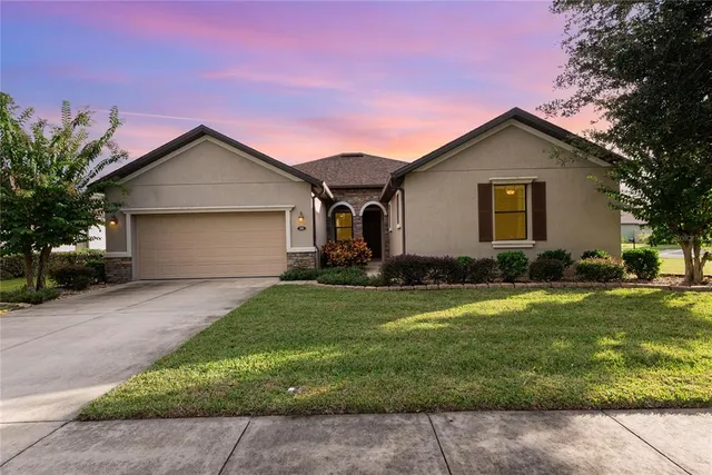 a front view of house with yard and green space