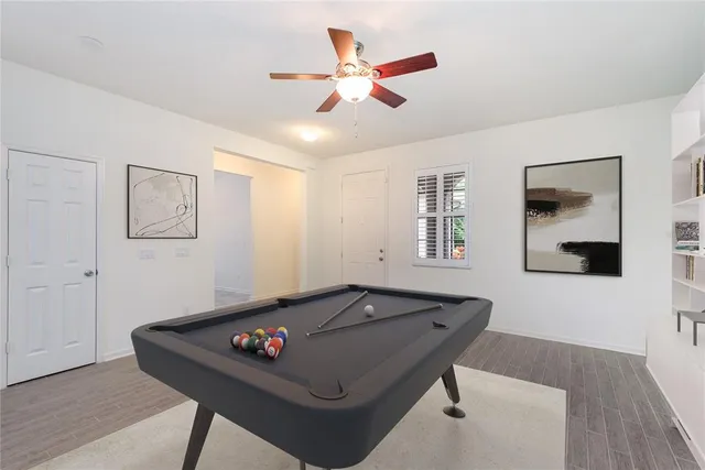 a living room with furniture and ceiling fan