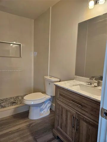a bathroom with a sink a toilet and a mirror