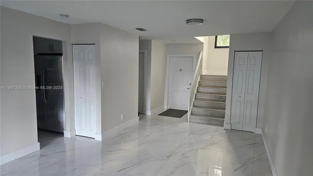 wooden view of an empty room with stairs