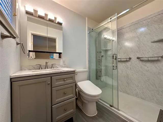 a bathroom with a sink toilet and shower