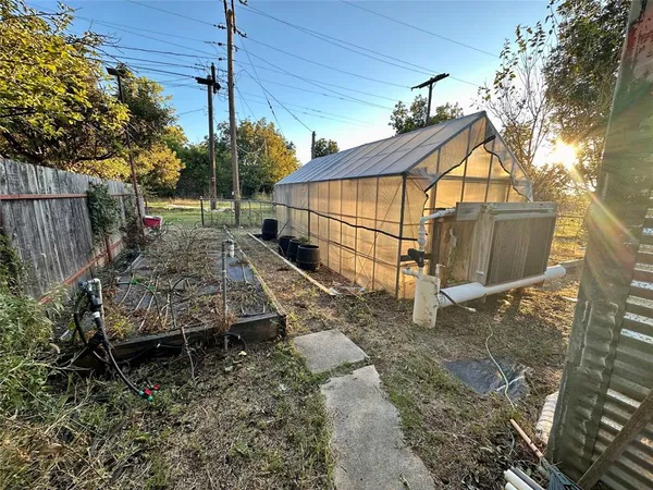 a view of a backyard with chairs and a grill