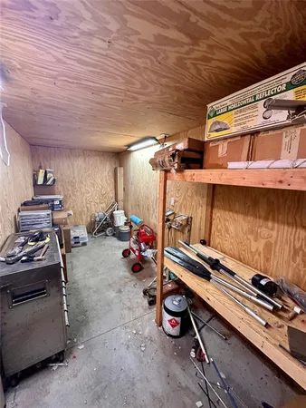 a backyard of a house with barbeque oven table and chairs