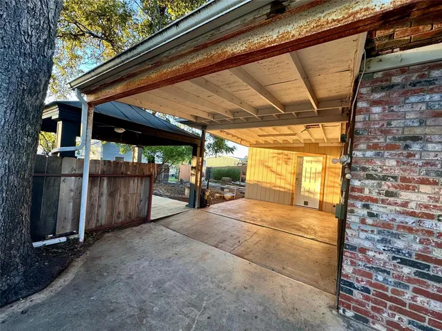 a backyard of a house with wooden floor and fence