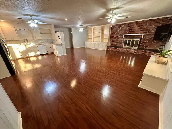 a view of a living room with wooden floor