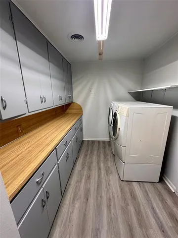 a view of kitchen and utility room with wooden floor