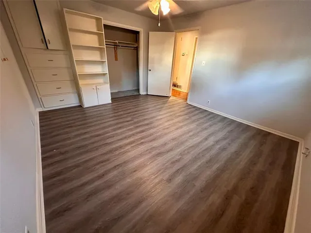 a view of walk in closet with empty racks