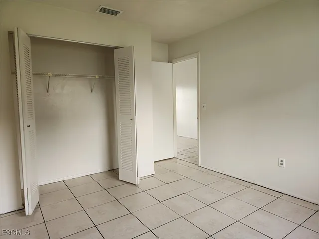 a view of a livingroom with a chandelier fan and window