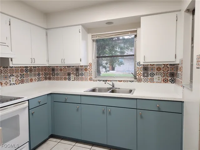 a kitchen with cabinets appliances and a sink