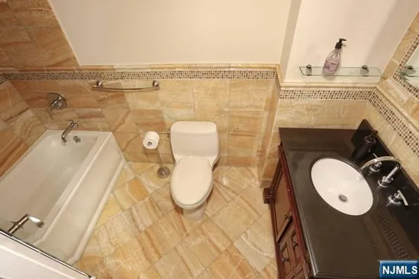 a bathroom with a sink mirror vanity and toilet