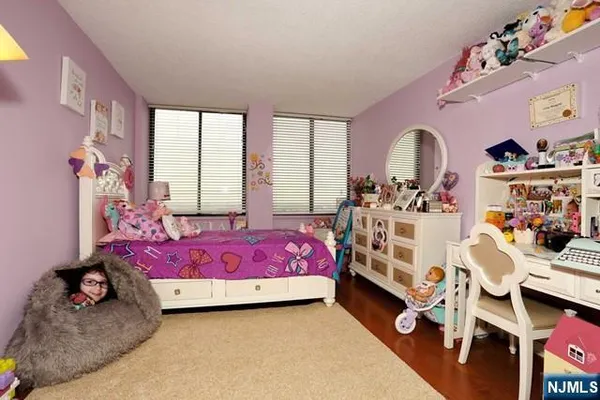 a bedroom with bed and a window