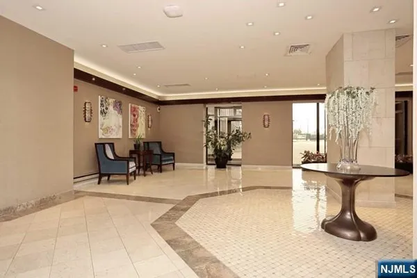 a lobby with furniture and floor to ceiling window