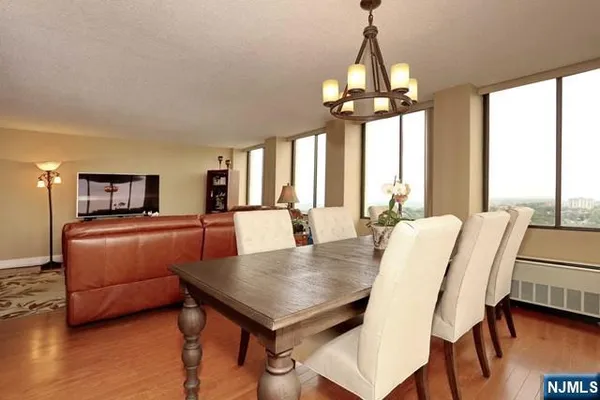 a view of a dining room with furniture window and wooden floor