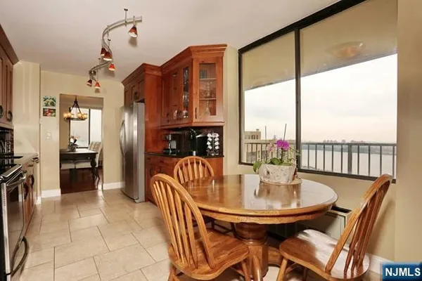 a dining room with furniture a chandelier and fireplace