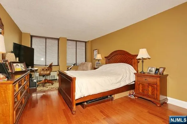 a bed room with a bed and a flat tv screen on a dresser