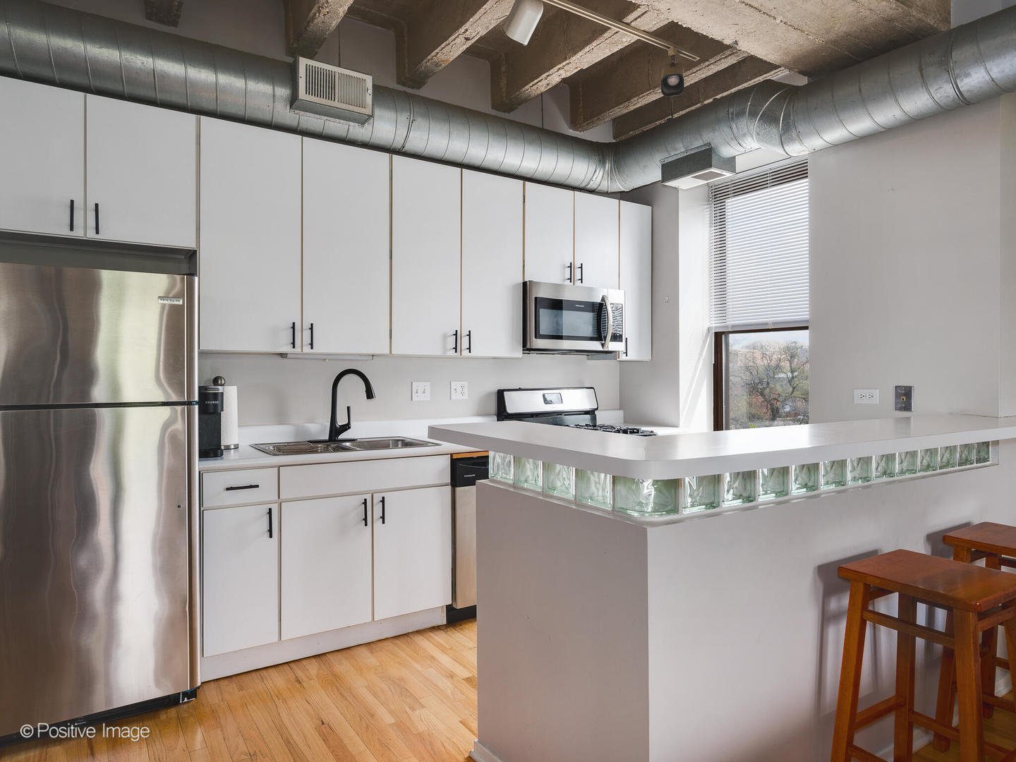 811 South Lytle Street, Unit 303 Chicago, IL 60607 - Photo 7 of 17 a kitchen with stainless steel appliances granite countertop a sink stove refrigerator and cabinets