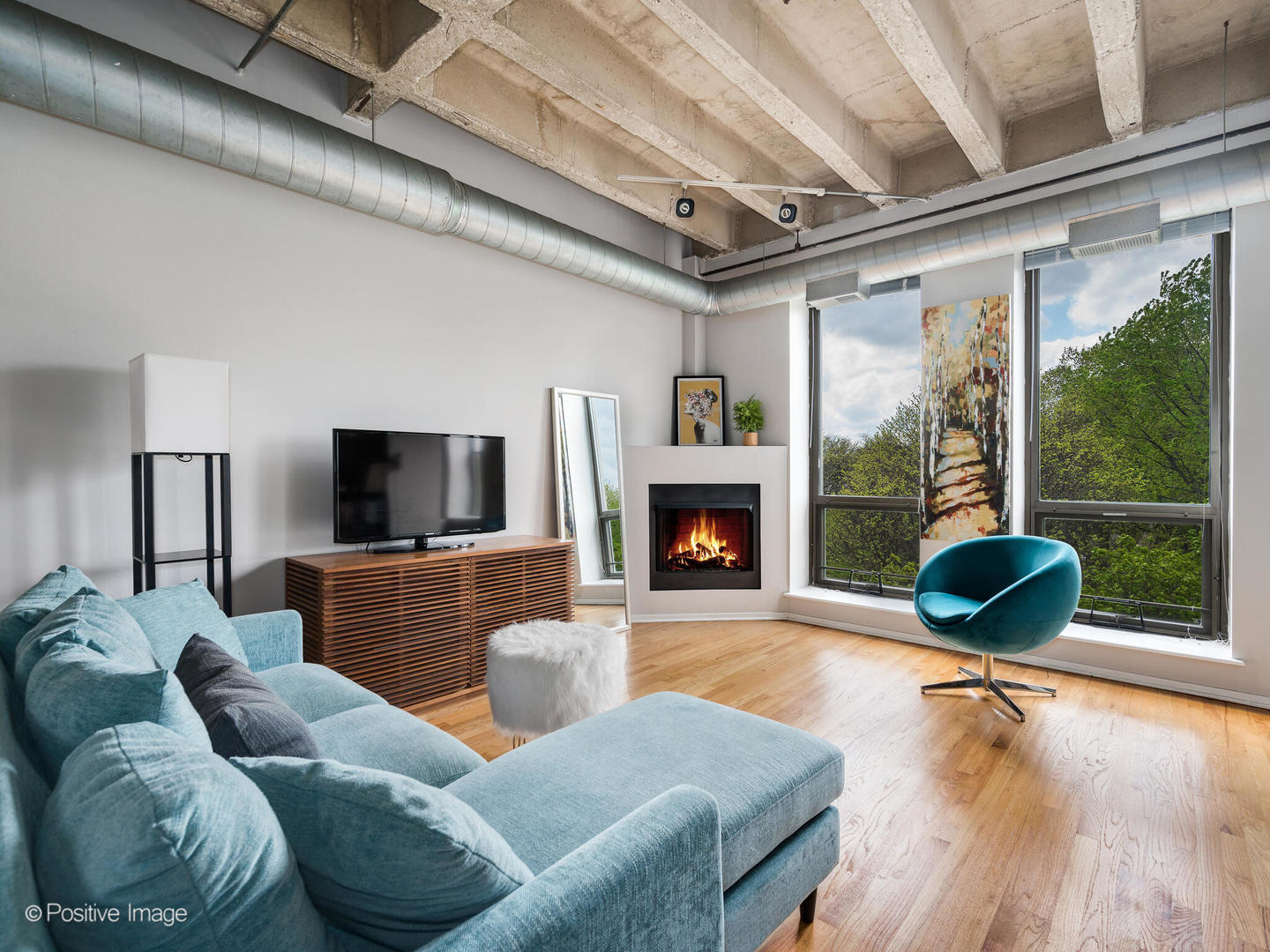 811 South Lytle Street, Unit 303 Chicago, IL 60607 - Photo 9 of 17 a living room with furniture a flat screen tv and a fireplace