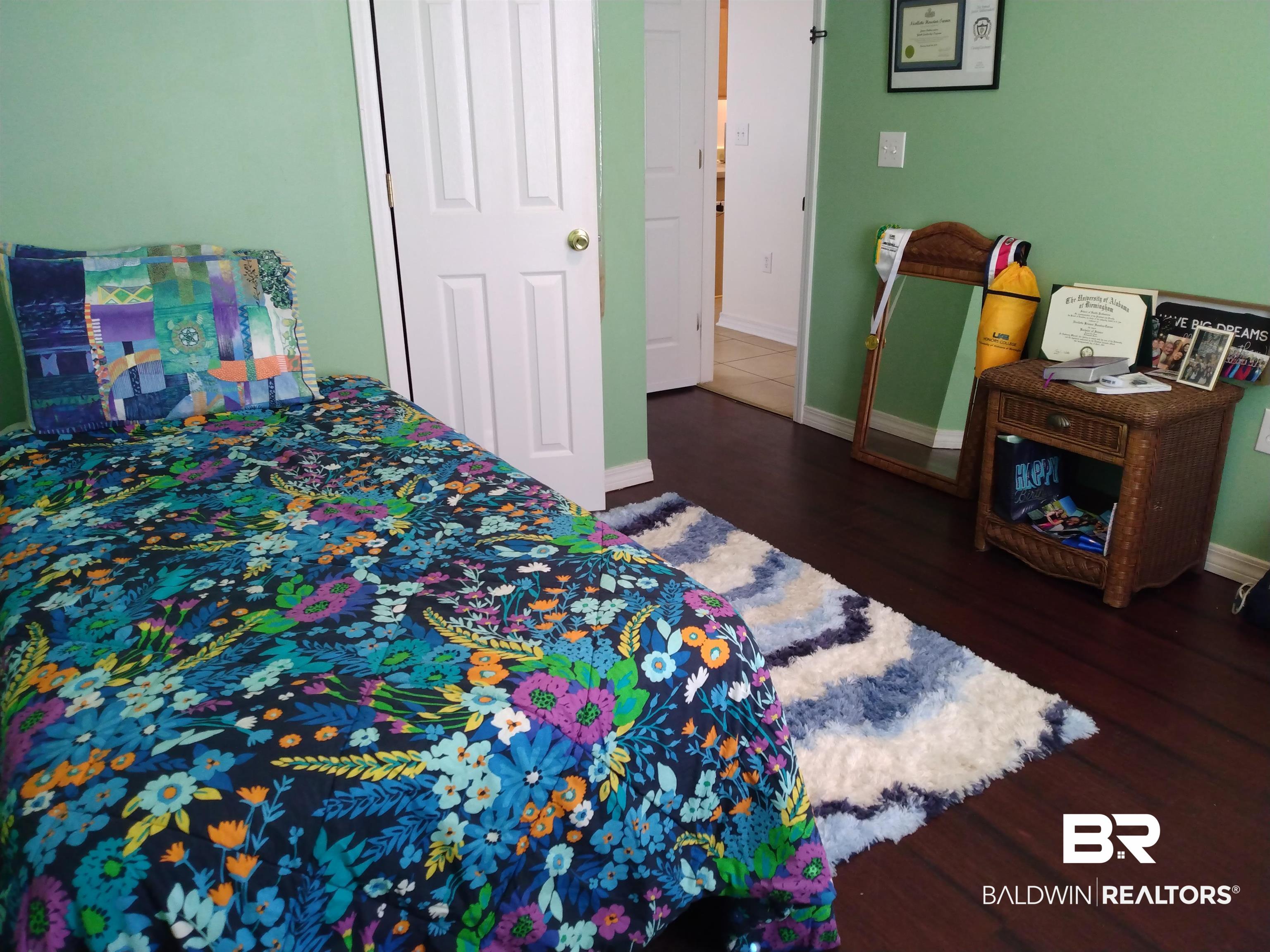 431 Hamilton Boulevard Foley, AL 36535 - Photo 18 of 30 Guest bedroom featuring dark wood-type flooring.