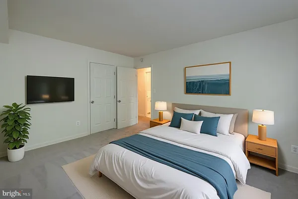 a bedroom with a bed and a flat screen tv