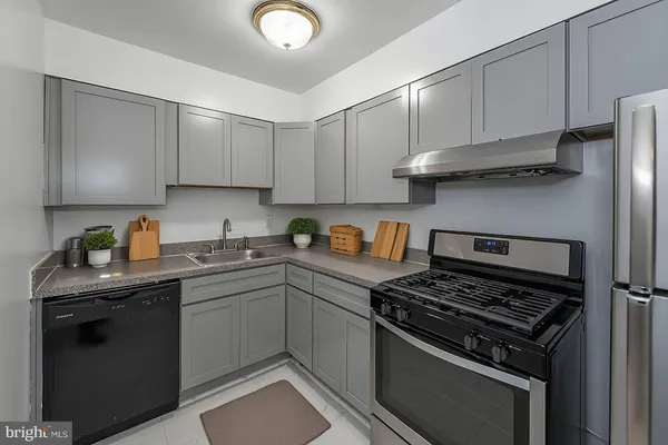 a kitchen with cabinets appliances and a sink