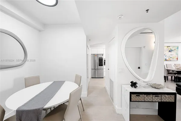 a dining room with a table chairs and flat screen tv