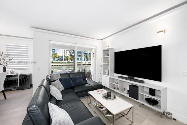 a view of a dining room with furniture and a chandelier