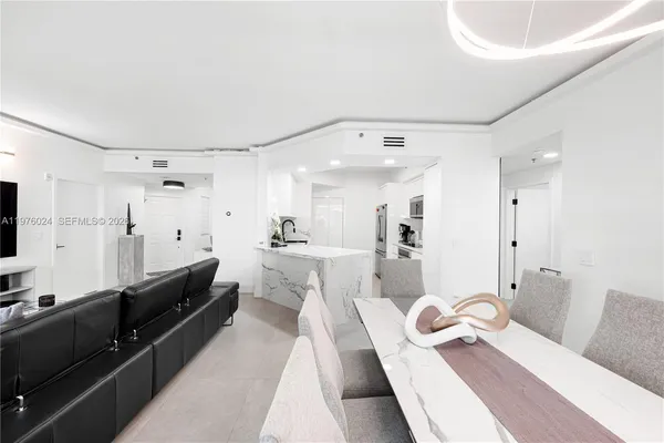 a kitchen with a sink stainless steel appliances and white cabinets