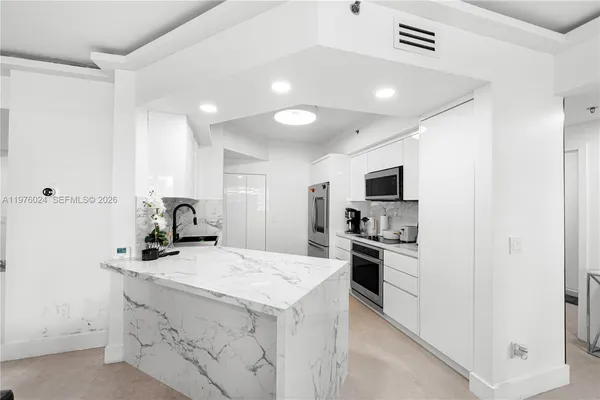 a view of a livingroom with furniture and a flat screen tv
