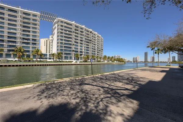 a view of swimming pool with outdoor seating and lake view