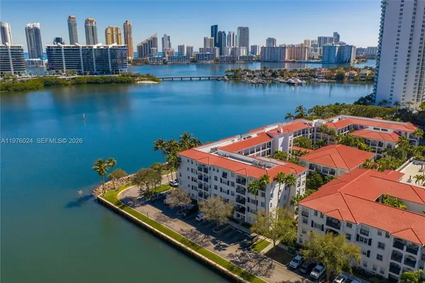 a view of a house with a yard and lake view