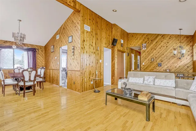 a living room with furniture pool table and a large window